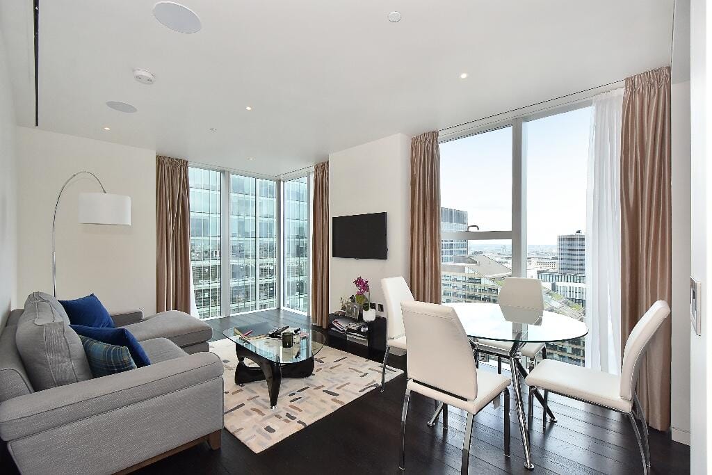 The herron living area and dining area with cityscape views