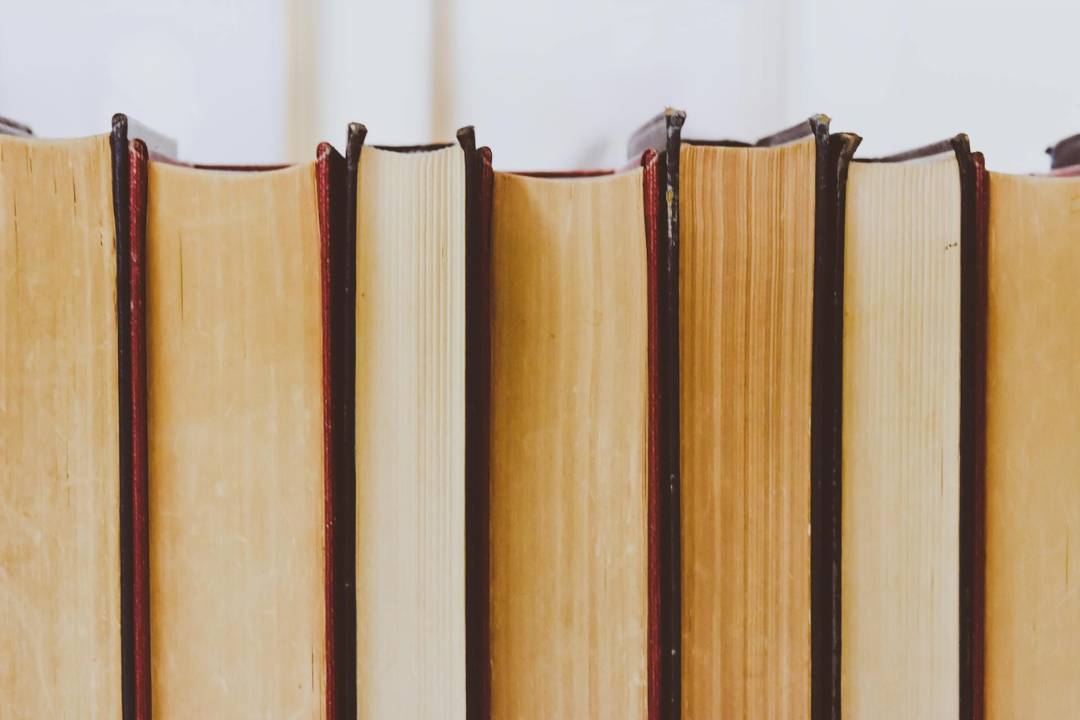 well-worn hardback books lined up