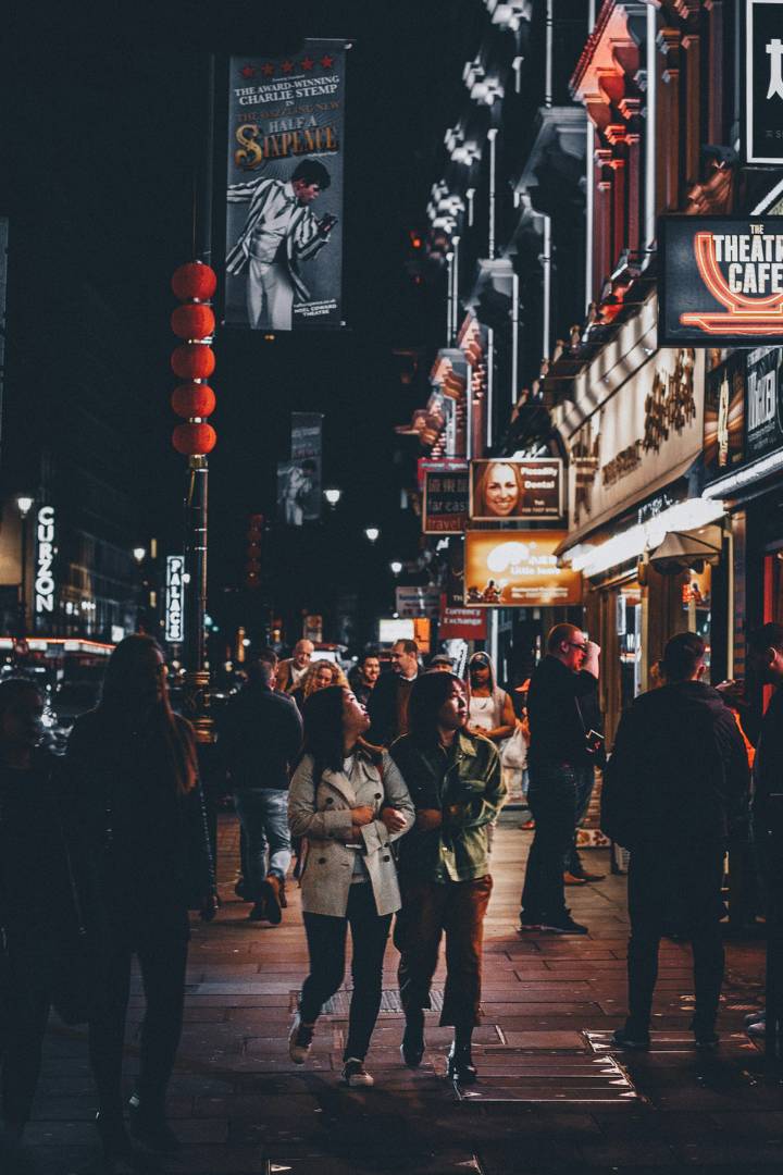 Two women walking past theatre cafe