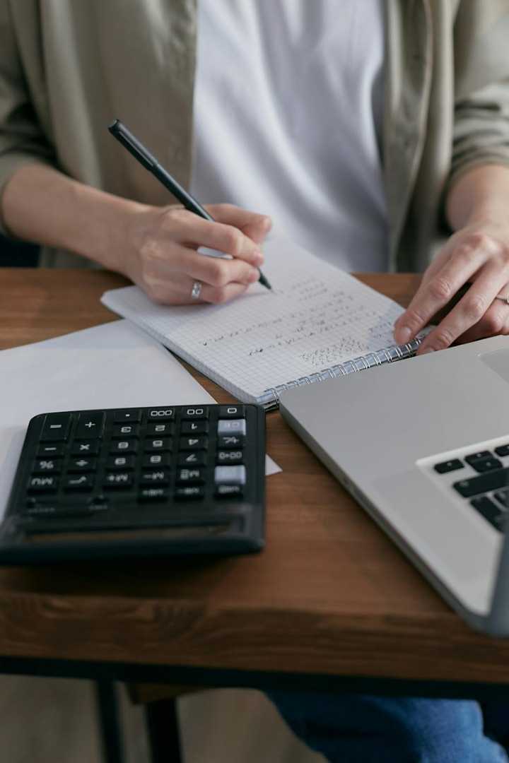 Person calculating on a notebook